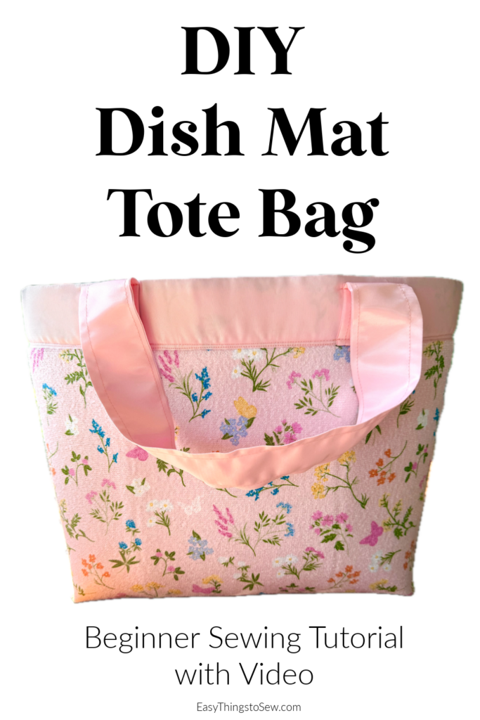 A handmade dish mat tote bag with pink handles and a floral pattern, shown with the text “DIY Dish Mat Tote Bag. Beginner Sewing Tutorial with Video.”.