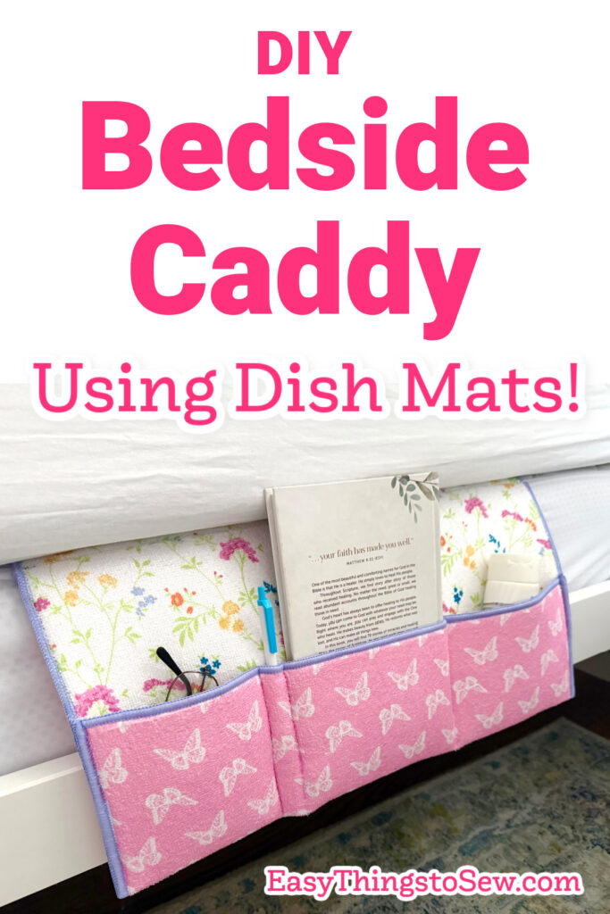 A pink and white fabric bedside caddy made from dish mats holds books and glasses, hanging from the side of a bed. Text reads, "DIY Bedside Caddy Using Dish Mats!.