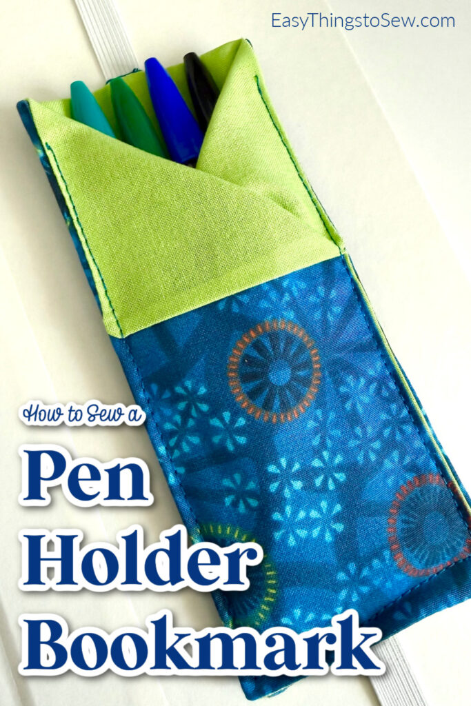 A fabric pen holder bookmark in blue and green, holding three pens, lies on an open book with "How to Sew a Pen Holder Bookmark" text overlay.