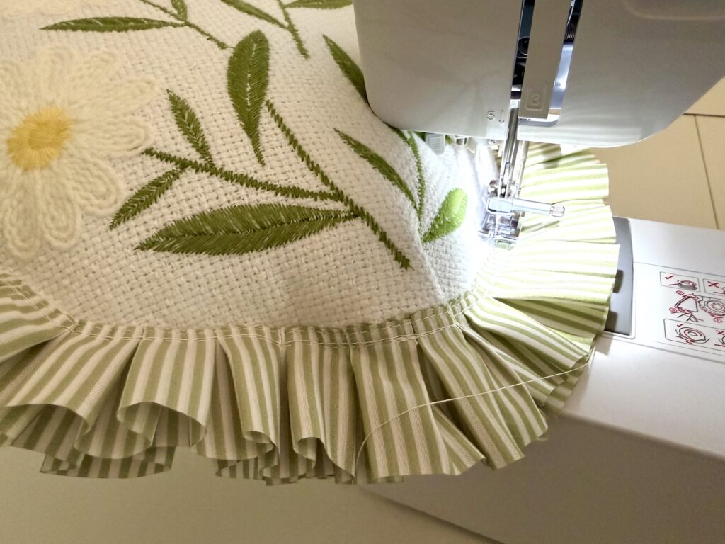 sewing machine needle stitching the opening closed on a placemat pillow