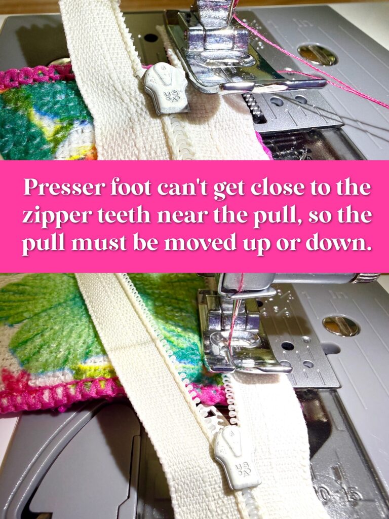 Close-up of a sewing machine presser foot unable to sew near the zipper pull; zipper pull blocks the foot from getting close to the zipper teeth.